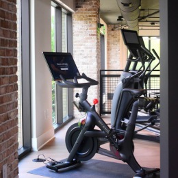 fitness center with exercise equipment and windows