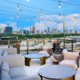 outdoor patio with tables and seating and hanging string lights