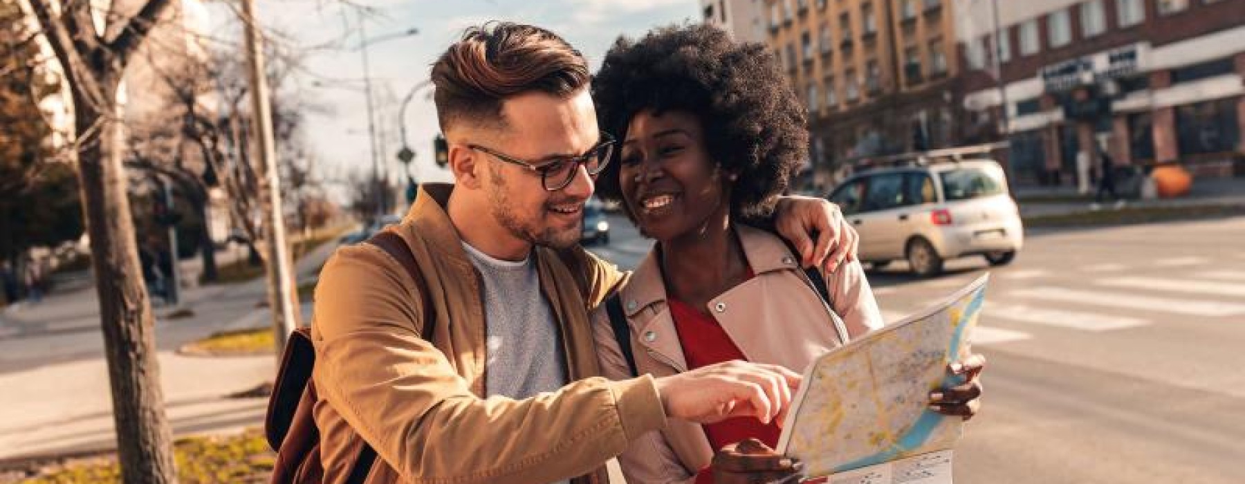 a man and woman looking at a map in the city